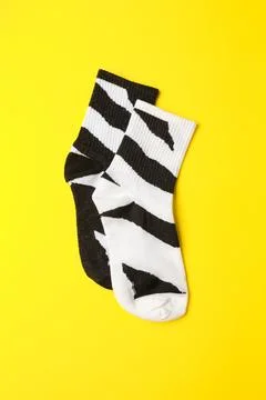 Pair of black and white funny socks with zebra skin pattern, aligned straight Stock Photos