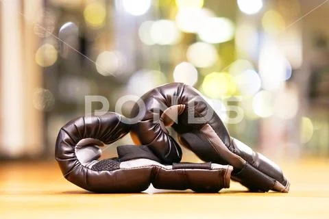 Pair of black box gloves in gym. Stock Photos