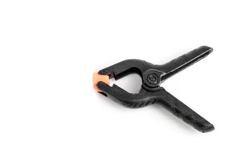 Pair of black clamp with orange plastic jaws, isolated over the white backg.. Fotos Stock