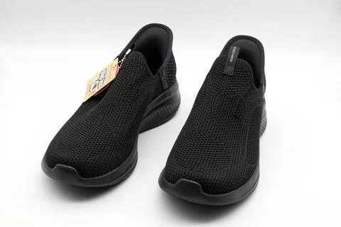 Pair of black comfortable athletic mesh slip on sneakers. Stock-Fotos