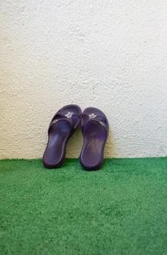 Pair of Black Flip-Flops on Artificial Grass Stock Photos