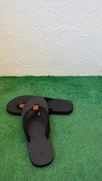 Pair of Black Flip-Flops on Artificial Grass Stock Photos