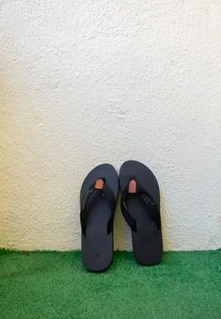 Pair of Black Flip-Flops on Artificial Grass Stock Photos