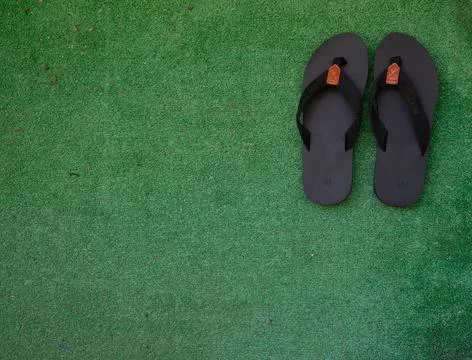 Pair of Black Flip-Flops on Artificial Grass Stock Photos