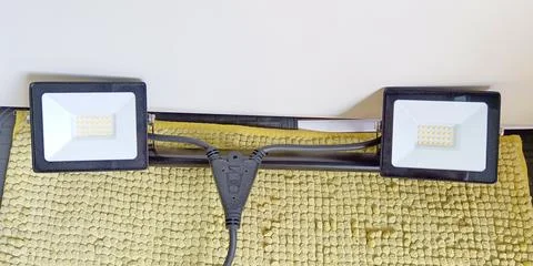 Pair of black LED floodlights with cables and power connector Stock Photos