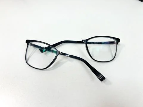 Pair of black plastic frame optical eyeglasses broken in the middle Stock Photos