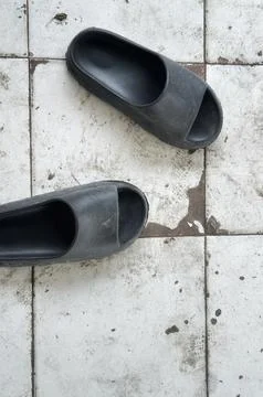 Pair of black sandals on vintage pattern Stock Photos