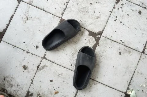 Pair of black sandals on vintage pattern Stock Photos