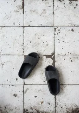 Pair of black sandals on vintage pattern Stock Photos