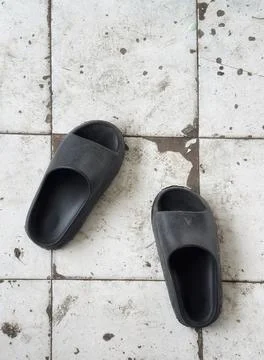 Pair of black sandals on vintage pattern Stock Photos