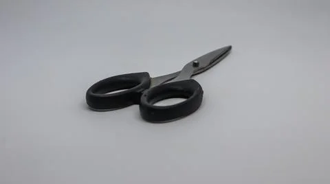 A pair of black scissors on a white background Foto stock