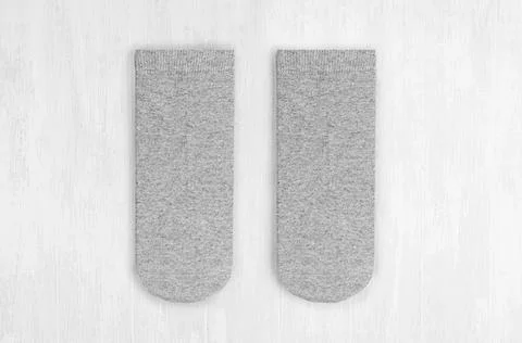 Pair blank grey medium socks flat lay on white wood board, front view - mock  Stock Photos