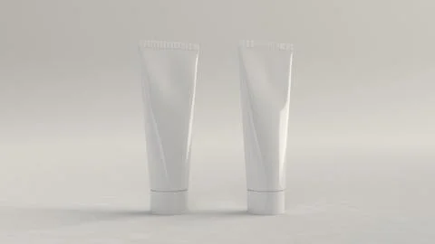 Pair of blank white tubes of toothpaste, cream or gel Illustrazione stock