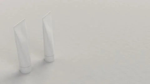 Pair of blank white tubes of toothpaste, cream or gel Illustrazione stock