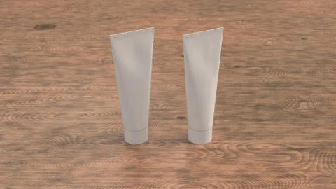 Pair of blank white tubes of toothpaste, cream or gel Illustrazione stock