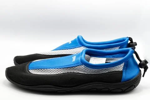 A pair of blue and black mesh water shoes. Stock Photos