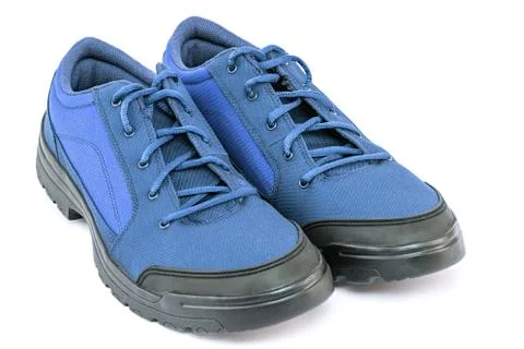 A pair of blue cheap durable fabric travel shoes isolated on white background Stock Photos