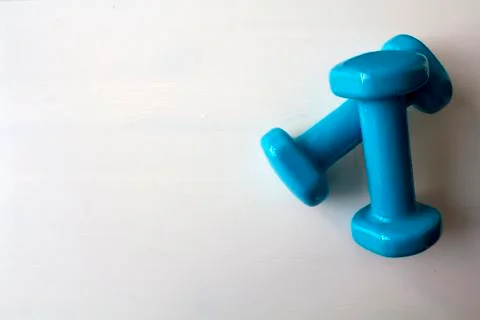 Pair of blue dumbbells on white background Stock Photos