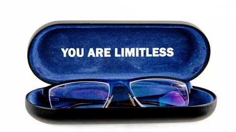 A pair of blue framed spectacles rests in a dark case that proclaims YOU ARE Stock Photos