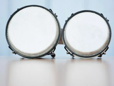 Pair of bongos on reflecting surface in studio Stock Photos