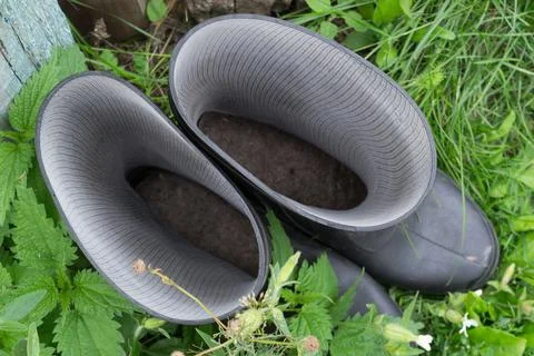 A pair of boots stand in the grass, view from above Stock Photos