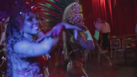 Pair of Brazilian samba dancers dancing side by side and clapping Stock Footage 80727129