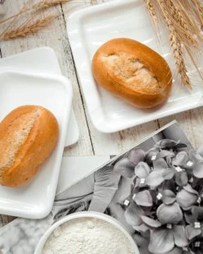 A pair of bread buns and wheat branches Stock Photos