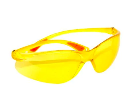 Pair of bright yellow plastic protective glasses Stock Photos