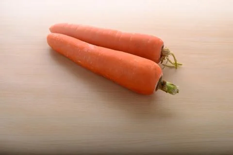 A pair of carrots on kitchen table top Stock Photos