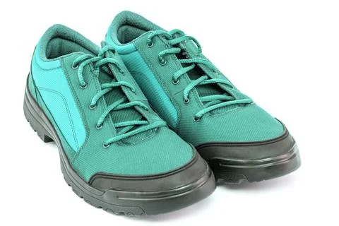 A pair of cheap aqua mint turquoise green hiking shoes isolated on white Stock Photos