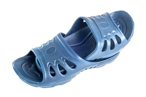 Pair of cheap durable blue rubber slippers one inside other isolated on white Stock Photos