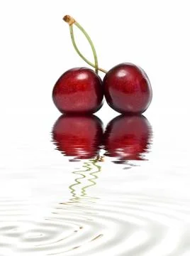 A pair of cherries reflected. Stock Photos