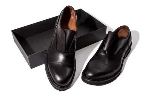 A pair of classic black colored laque leather boots Stock Photos
