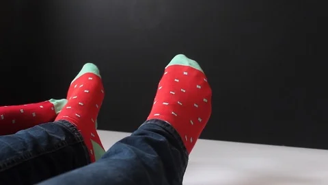 A pair in colorful socks caress each other for Christmas. Love of man and woman. Stock-Footage 88399329