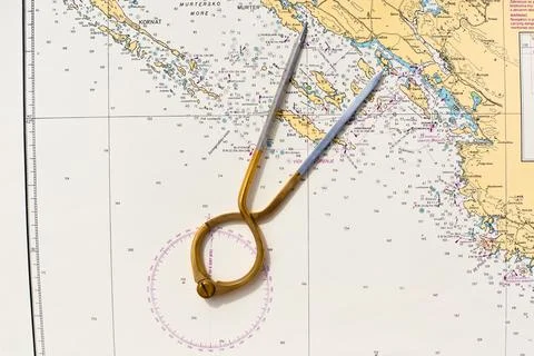 Pair of compasses for navigation on a sea map Fotos Stock