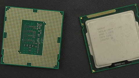 Pair of Computer Processors Intel on Dark Surface Highlighting Circuit Details Stock Footage 338045506