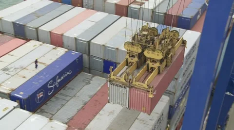 Pair of containers being unloaded from ship Stock Footage 1079257