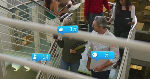 Pair of coworkers heading to lower level, tech bubbles popping from live feed Stock Footage 329909338