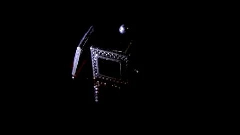 A pair of cufflinks ligthing on a dark background Stock Footage 102327225
