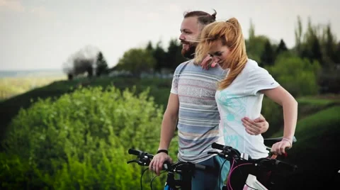 A pair of cyclists on the hill. The guy shows the girl further route. Stock Footage 67148160
