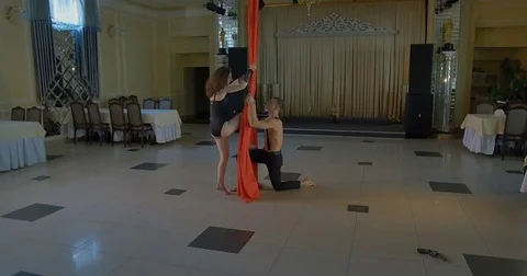 Pair of dancers on red aerial silk, aerial contortion Stock Footage 75780679