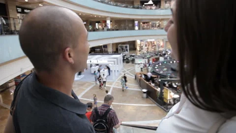 The pair descends the escalator to the Mall Stock Footage 111366112