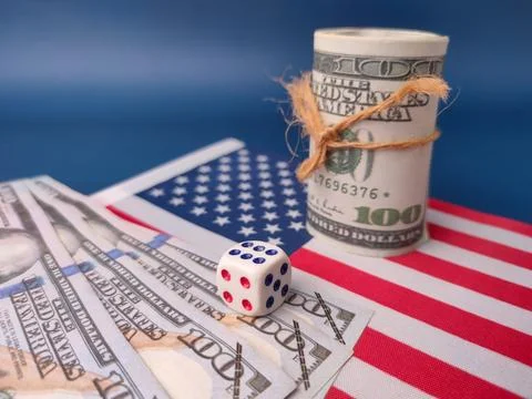 Pair of dice resting on a stack of US dollar bills placed over a representa.. Stock Photos