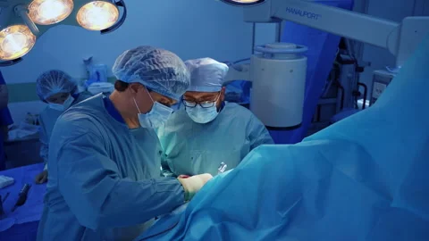 Pair of doctors use diverse instruments in the trauma operation Stock Footage 234089354