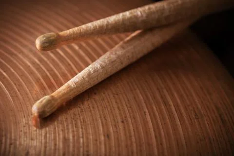 Pair of drumsticks lying on cymbal. Stock Photos