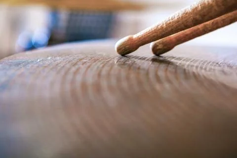 Pair of drumsticks lying on cymbal. Stock Photos