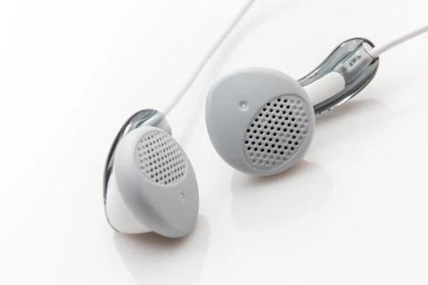 A pair of ear buds on a white background. Stock Photos