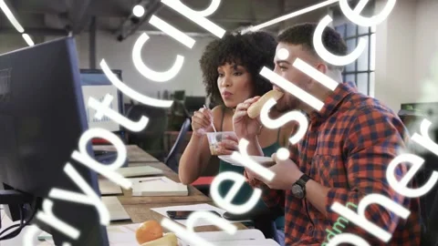 Pair eating at desk, checking finance chart while code overlay obscuring then Stock Footage 332841461
