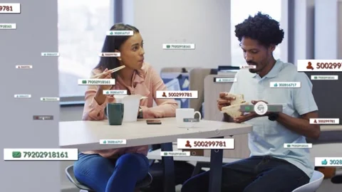 Pair eating at work, time passing causing floating UI labels around them showing 库存影片 331272853