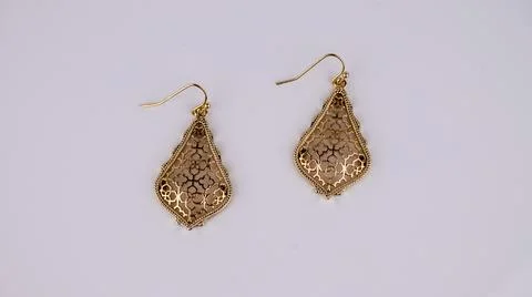 Pair of elegant gold earrings isolate Stock Photos